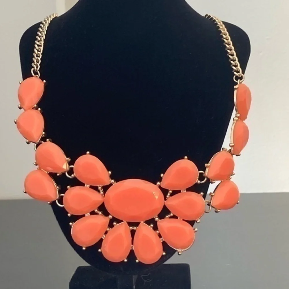Orange and golden bib necklace.